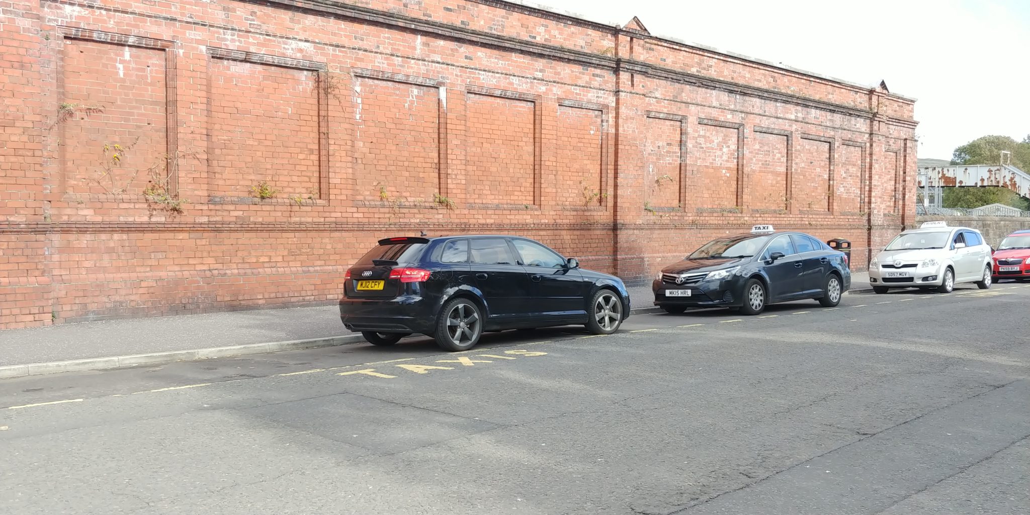 An entitled driver of a black Audi parks head on into the station rank