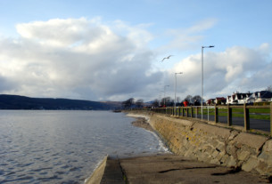 A seagull soaring above the slipway beside the river Clyde toward the west of Helensburgh
