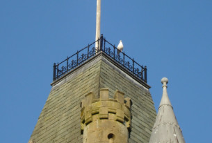 A seagull perched on the railing atop the tower of Victoria Halls, Helensburgh