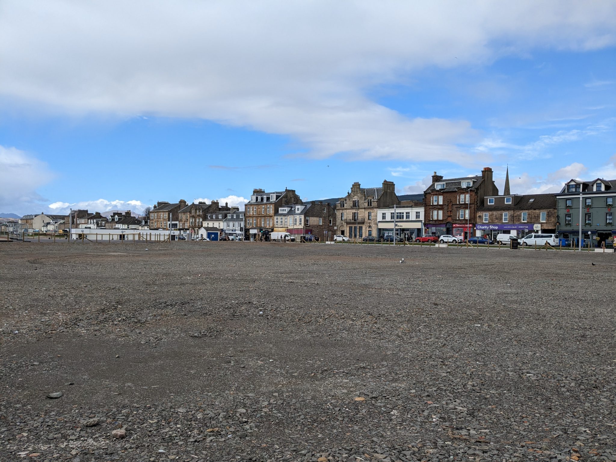 The barren grey site at the pierhead in Helensburgh is shown beneath cloudy blue skies