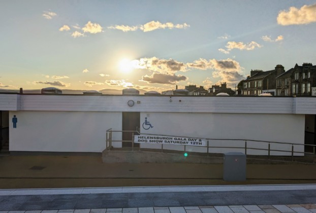 The public toilets at Helensburgh pier adorned with a banner for the gala day and dog show.