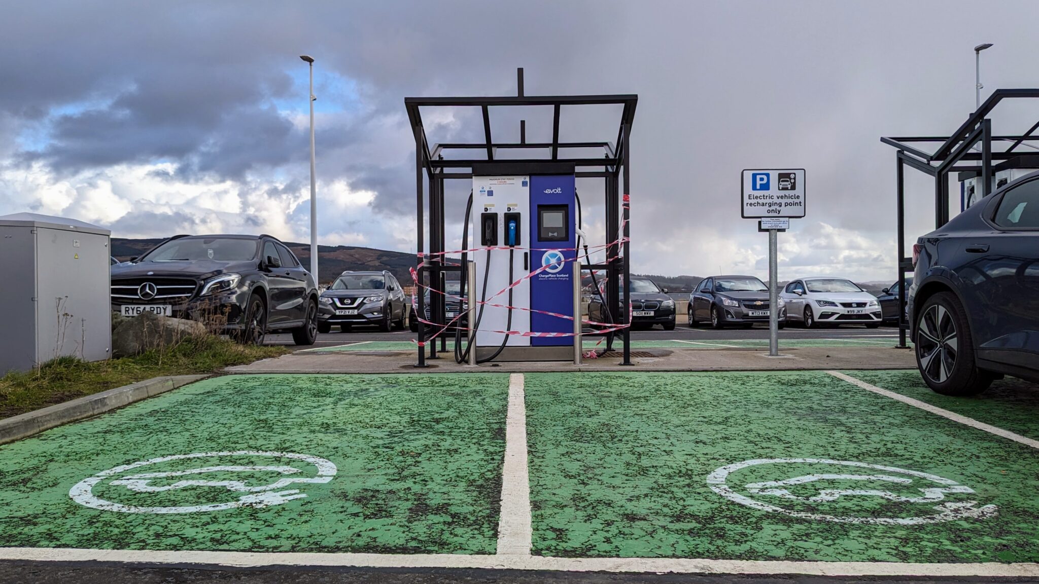 An out of order EV rapid charger at the front of two EV parking bays in Helensburgh's Leisure Centre car park