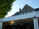 A seagull soaring above the rooftops of Helensburgh's Civic Centre, with a marquee full of revellers in the foreground.